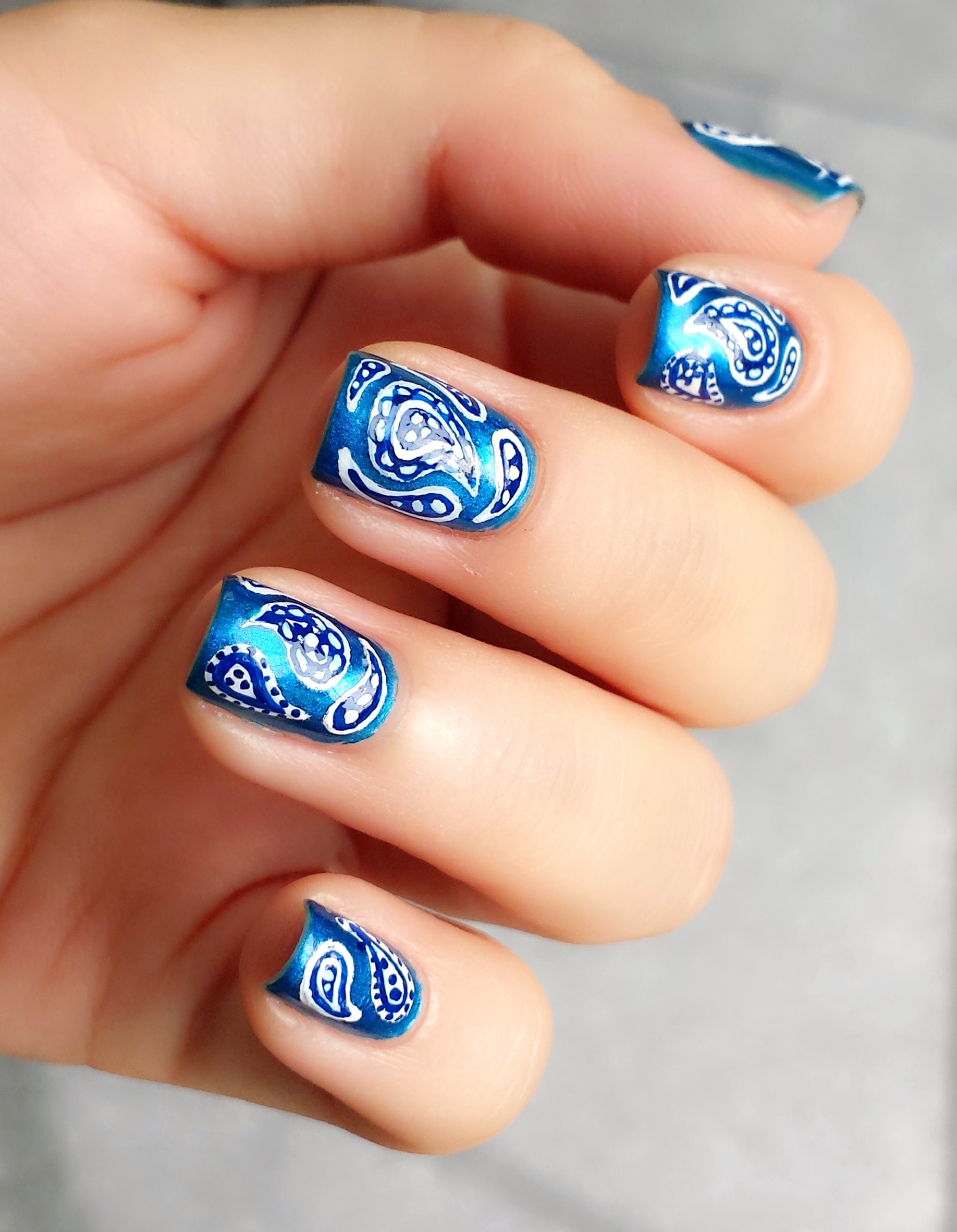 Blue paisley nail design.